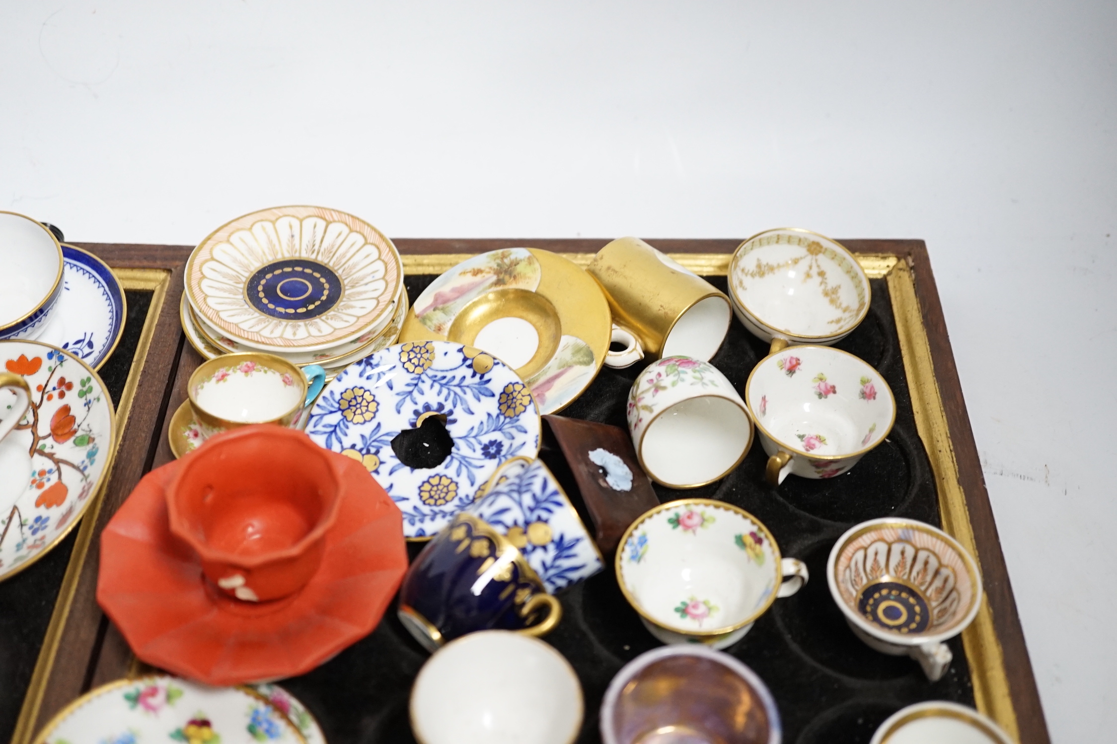 Collection of miniature porcelain cups and saucers including Spode, Royal Crown Derby and Coalport